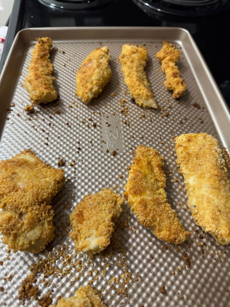 A sheet of gluten free crispy chicken tenders