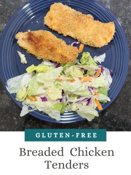 This image is of crispy chicken tenders with a side of salad.